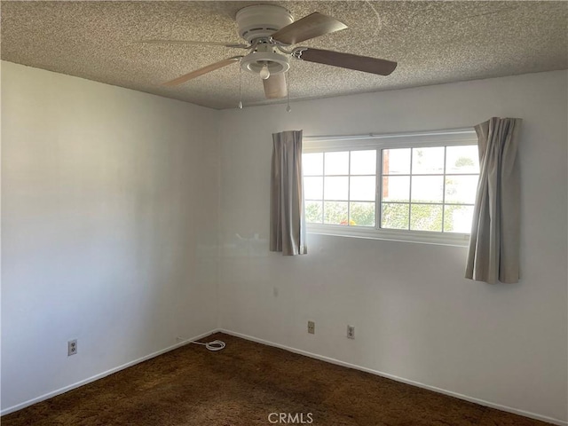 carpeted empty room with ceiling fan and a textured ceiling