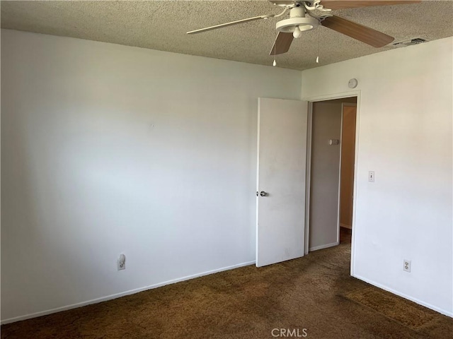 carpeted empty room with a textured ceiling and ceiling fan