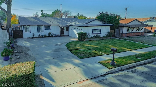 single story home with a front yard and a garage