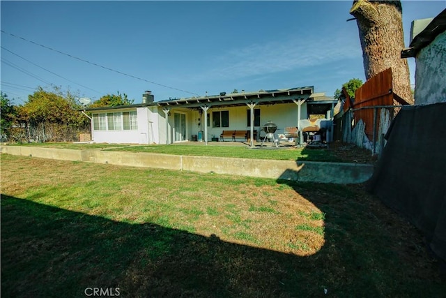 back of property featuring a yard and a patio