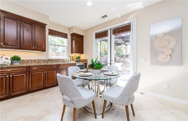 tiled dining area featuring french doors