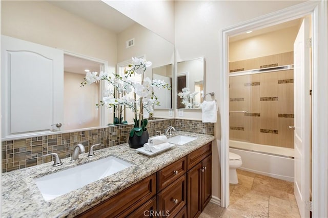 full bathroom featuring vanity, backsplash, toilet, and tiled shower / bath combo