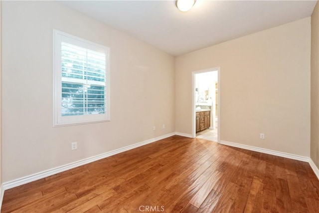 unfurnished room featuring hardwood / wood-style flooring