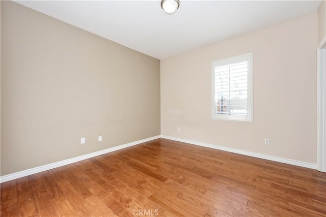 spare room with wood-type flooring