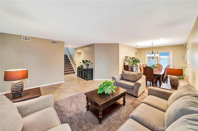 living room with light tile patterned floors and a notable chandelier