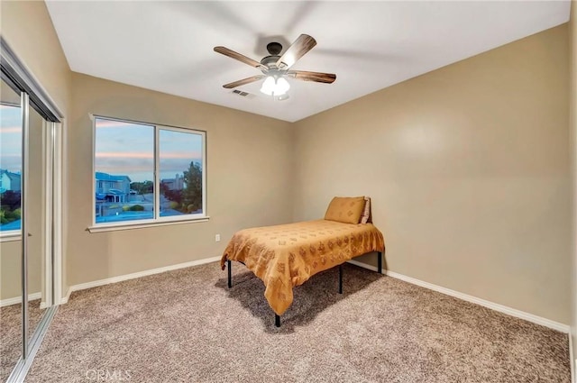 bedroom featuring carpet flooring, ceiling fan, and a closet