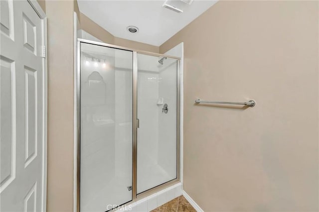 bathroom with a shower with door