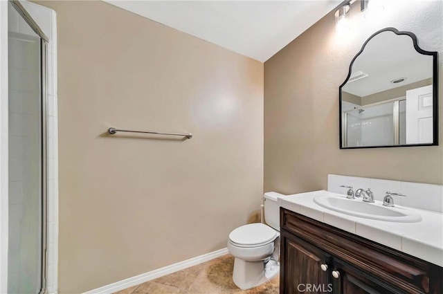 bathroom with vanity, toilet, and a shower with shower door