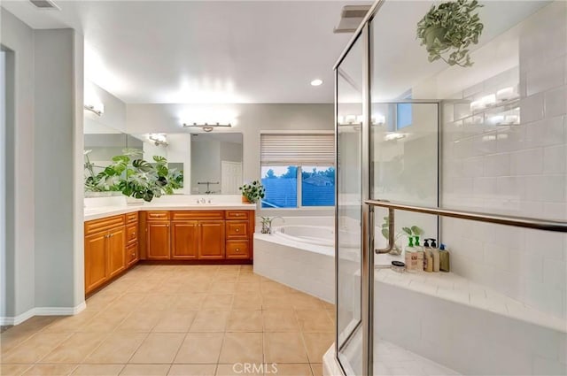 bathroom with shower with separate bathtub, vanity, and tile patterned floors