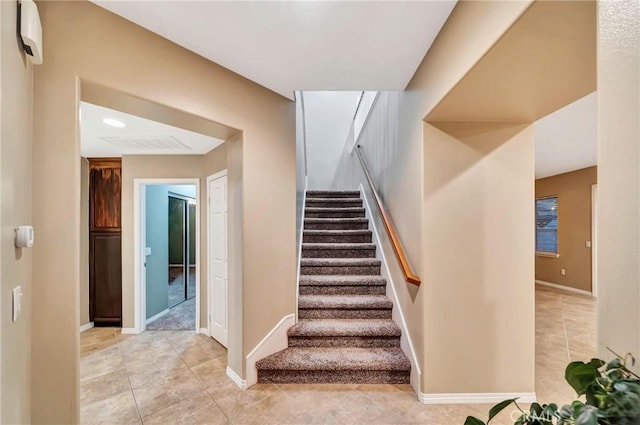 stairway with tile patterned floors