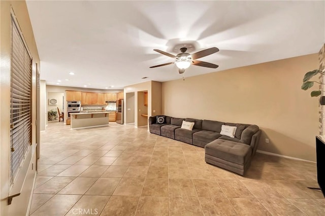 tiled living room with ceiling fan