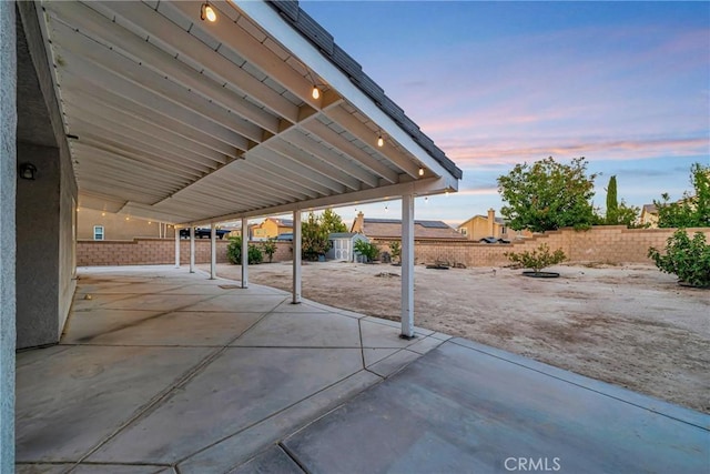 view of patio terrace at dusk