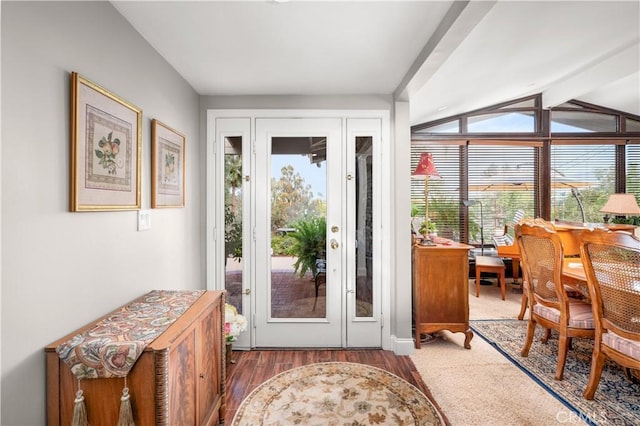 entryway with vaulted ceiling with beams and dark wood-type flooring