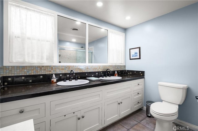 bathroom with toilet, vanity, tile patterned floors, decorative backsplash, and an enclosed shower