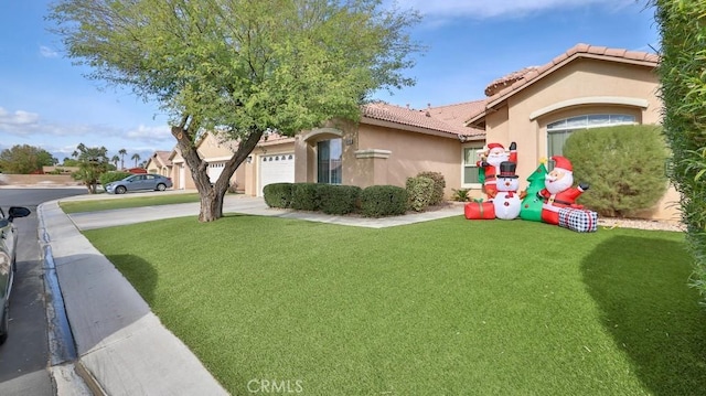 view of front of property with a garage and a front lawn