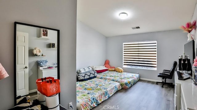 bedroom with dark hardwood / wood-style flooring