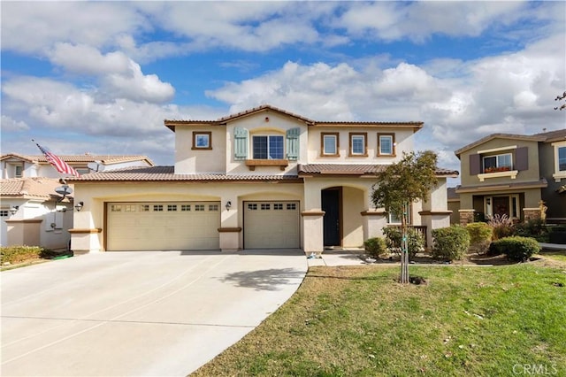 mediterranean / spanish-style home with a garage and a front lawn