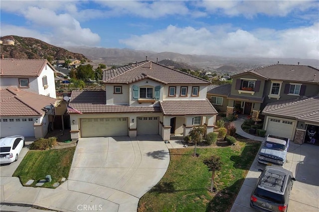 mediterranean / spanish home with a mountain view and a garage