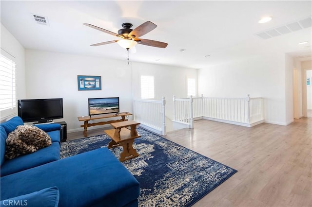 living room with ceiling fan, hardwood / wood-style floors, and a healthy amount of sunlight