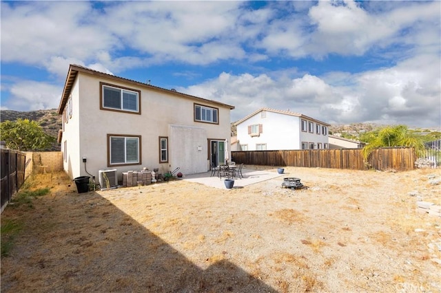 rear view of house featuring a patio and central AC unit