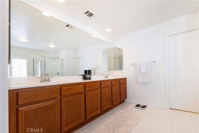 bathroom with tile patterned flooring, vanity, and a shower with shower door