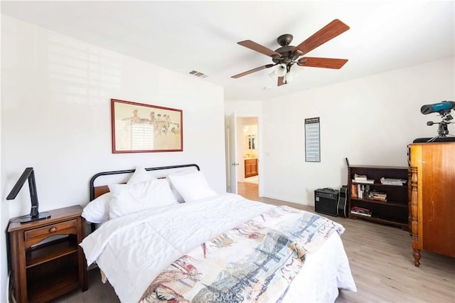 bedroom with ceiling fan and light hardwood / wood-style floors