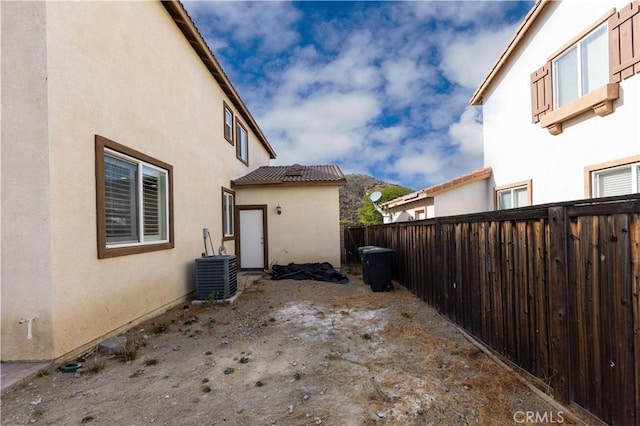 view of side of home featuring central AC