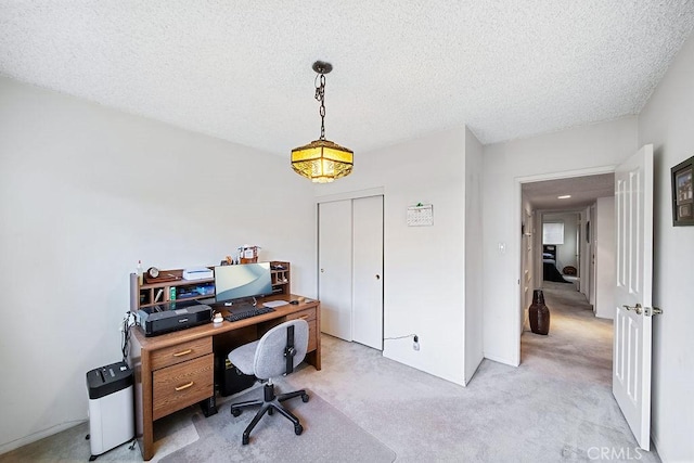 office space with light carpet and a textured ceiling