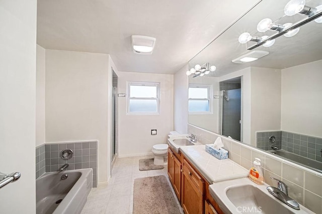 full bathroom featuring tile patterned flooring, vanity, toilet, and independent shower and bath