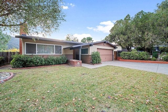 single story home with a garage and a front lawn