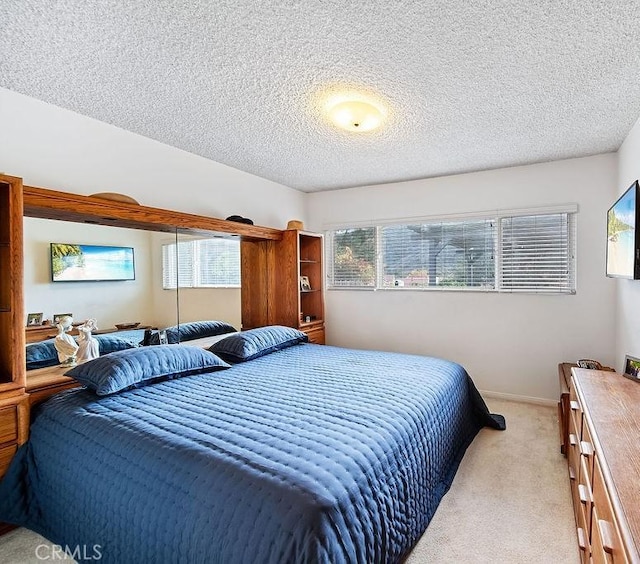 carpeted bedroom featuring a textured ceiling