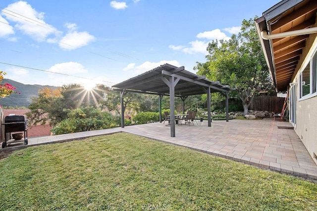 view of yard featuring a mountain view, a pergola, and a patio