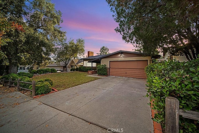 single story home with a yard and a garage