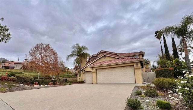 view of property exterior featuring concrete driveway, a tiled roof, a garage, and stucco siding