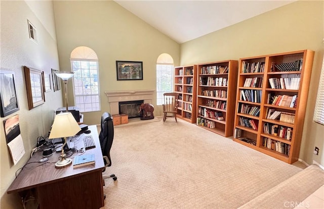 office featuring plenty of natural light, a fireplace, carpet, and visible vents