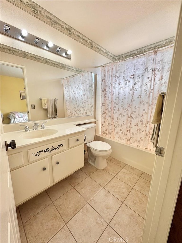 bathroom featuring toilet, shower / bath combo, ensuite bathroom, tile patterned floors, and vanity