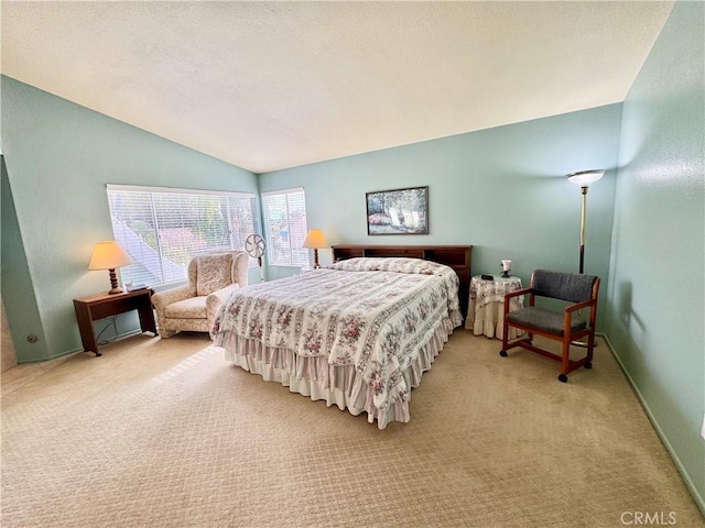 bedroom featuring baseboards, light colored carpet, a textured ceiling, and lofted ceiling