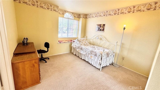 carpeted bedroom featuring baseboards