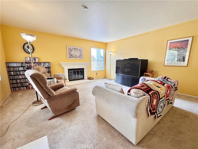 living area featuring baseboards, carpet, and a glass covered fireplace