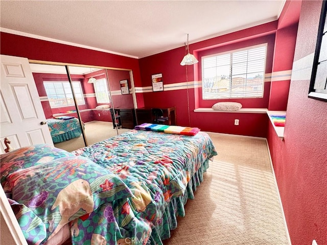 bedroom featuring a closet, carpet, and a textured wall