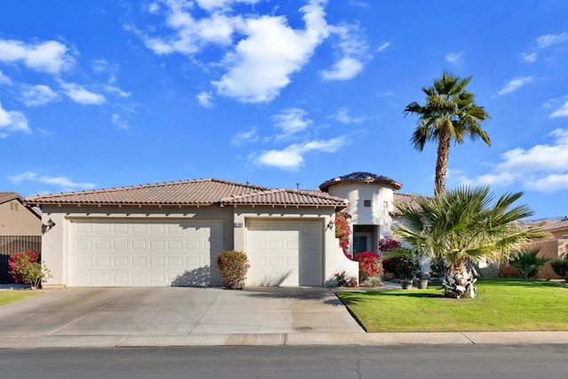 mediterranean / spanish-style house featuring a garage and a front lawn