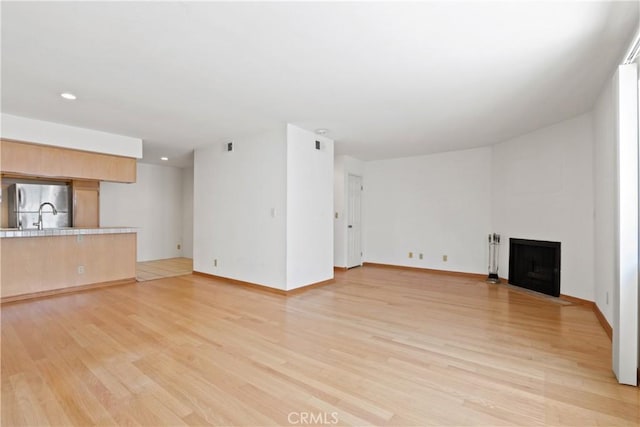 unfurnished living room featuring light hardwood / wood-style flooring