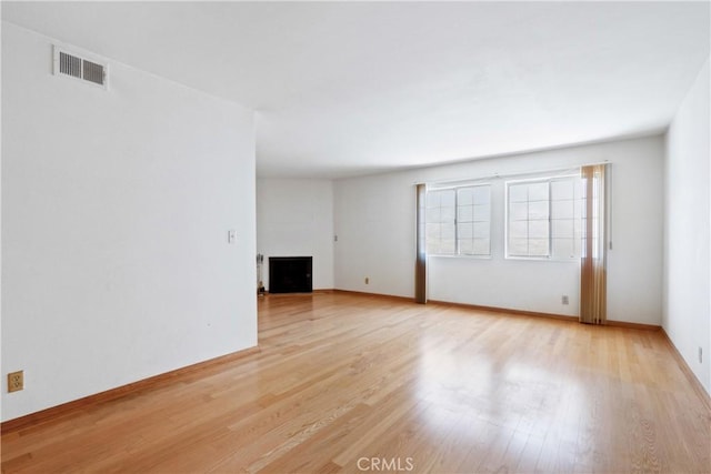 unfurnished room with light hardwood / wood-style floors