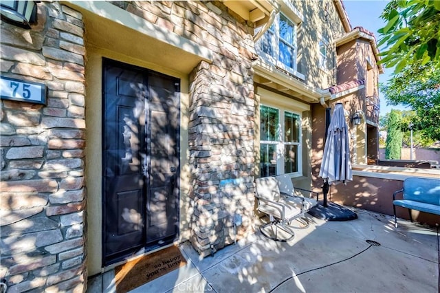 doorway to property with a patio