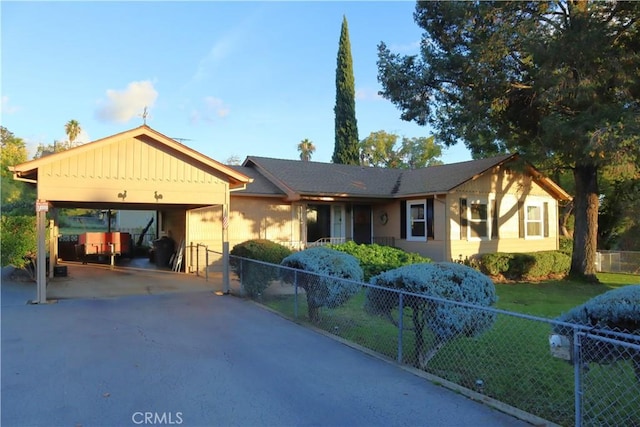 view of front of property with a carport and a front lawn