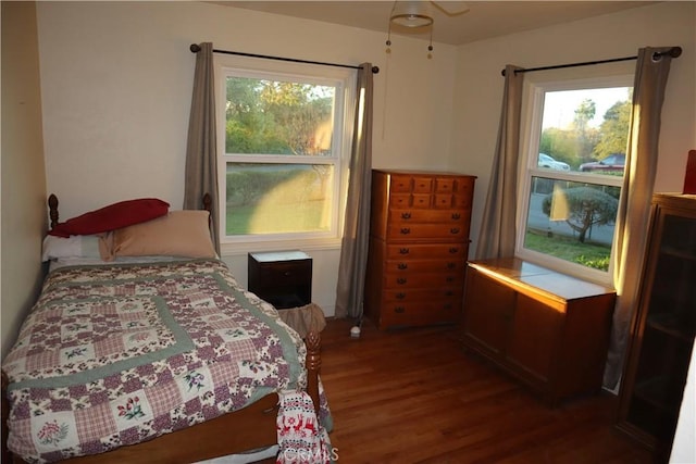 bedroom with dark hardwood / wood-style floors