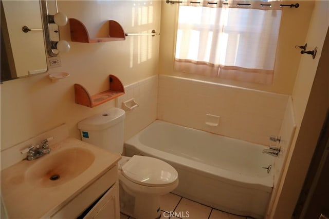 bathroom featuring tile patterned flooring, a bathing tub, vanity, and toilet