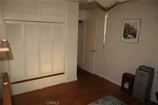 bedroom with dark hardwood / wood-style floors and ceiling fan