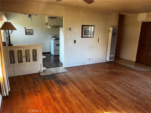 empty room featuring ceiling fan and dark hardwood / wood-style floors