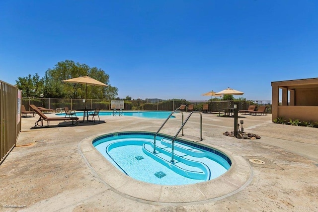 view of pool with a patio area and a community hot tub